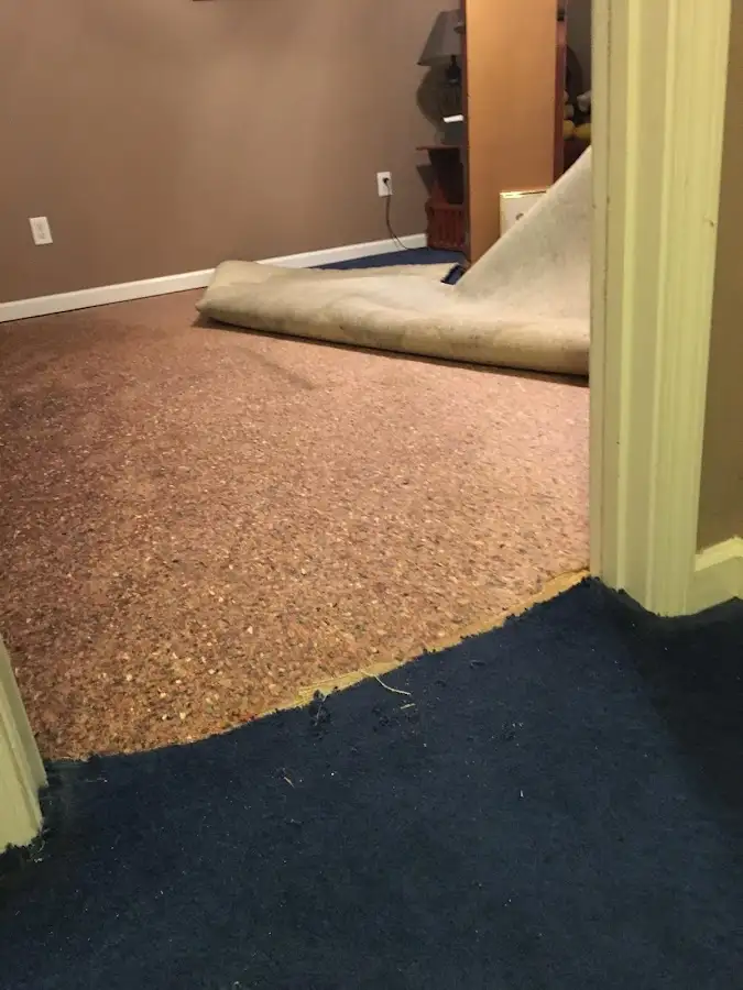 Carpet pad removal revealing water damage during Drying & Dehumidification in Henryetta
